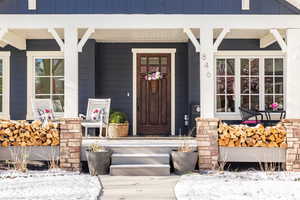 View of exterior entry with covered porch