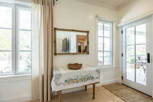 Entryway featuring hardwood / wood-style floors and crown molding