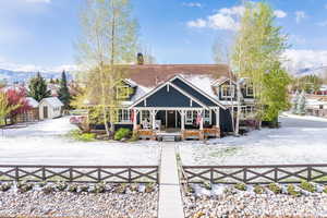 Rear view of house featuring a fenced front yard and a mountain view