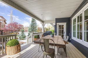 Deck with outdoor dining space and a grill