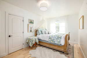 Bedroom featuring baseboards and light wood-style floors
