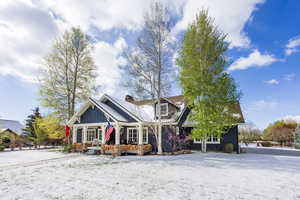 Craftsman-style home featuring board and batten siding and a chimney