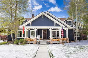 View of front of home featuring a porch and a chimney