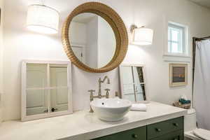 Bathroom featuring vanity and a shower with shower curtain