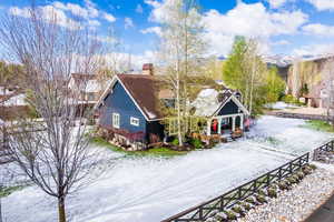 View of front of house featuring covered porch and a chimney