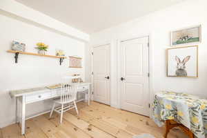 Home office featuring light wood-style flooring and baseboards