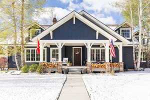 Craftsman-style house featuring a porch and a chimney