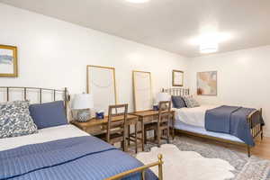 Bedroom featuring wood finished floors and a textured ceiling
