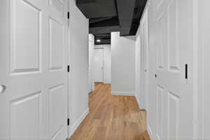 Hallway featuring baseboards and light wood-type flooring
