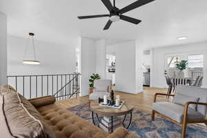 Living room featuring wood finished floors and a ceiling fan