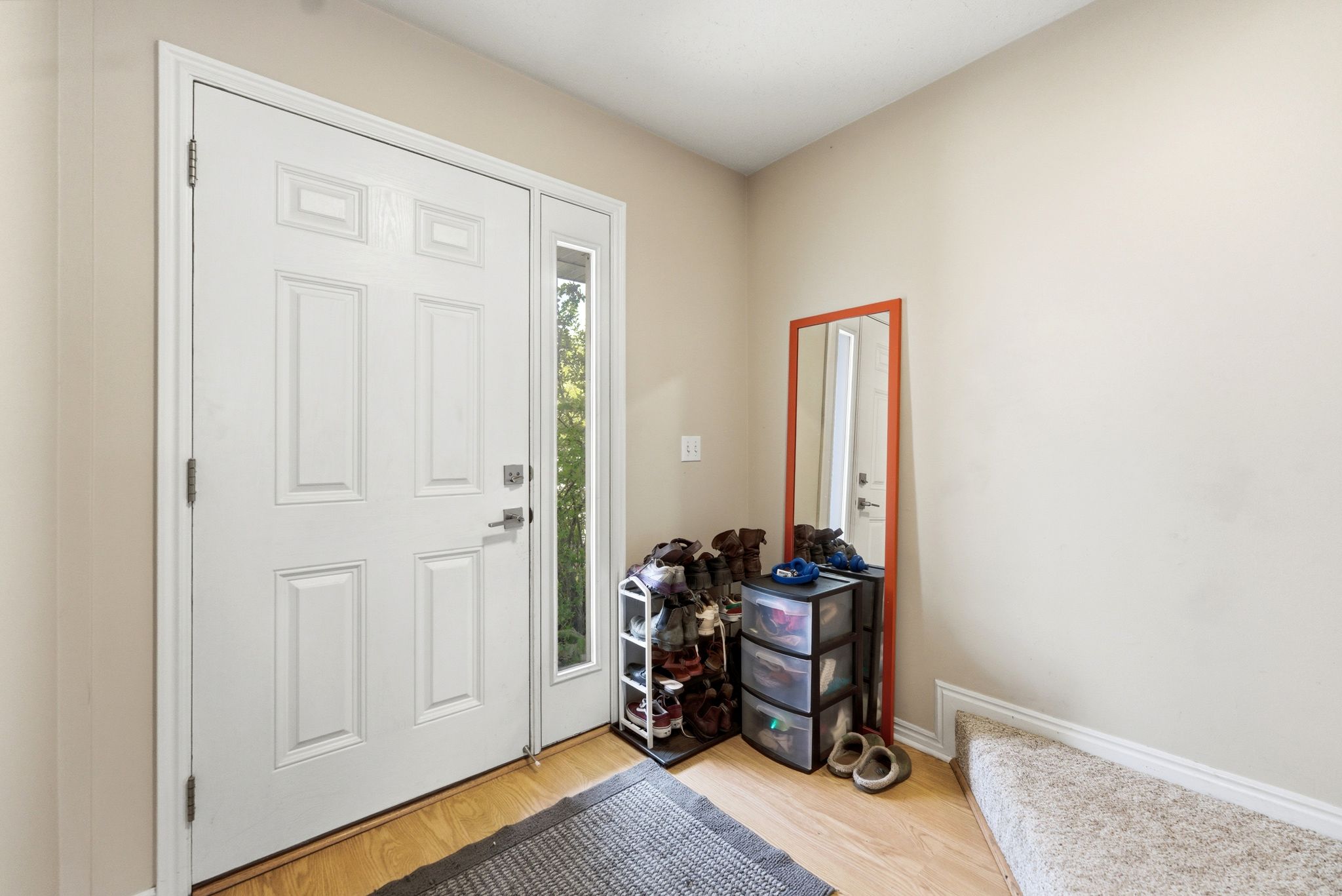 Entryway with light wood-style floors and baseboards