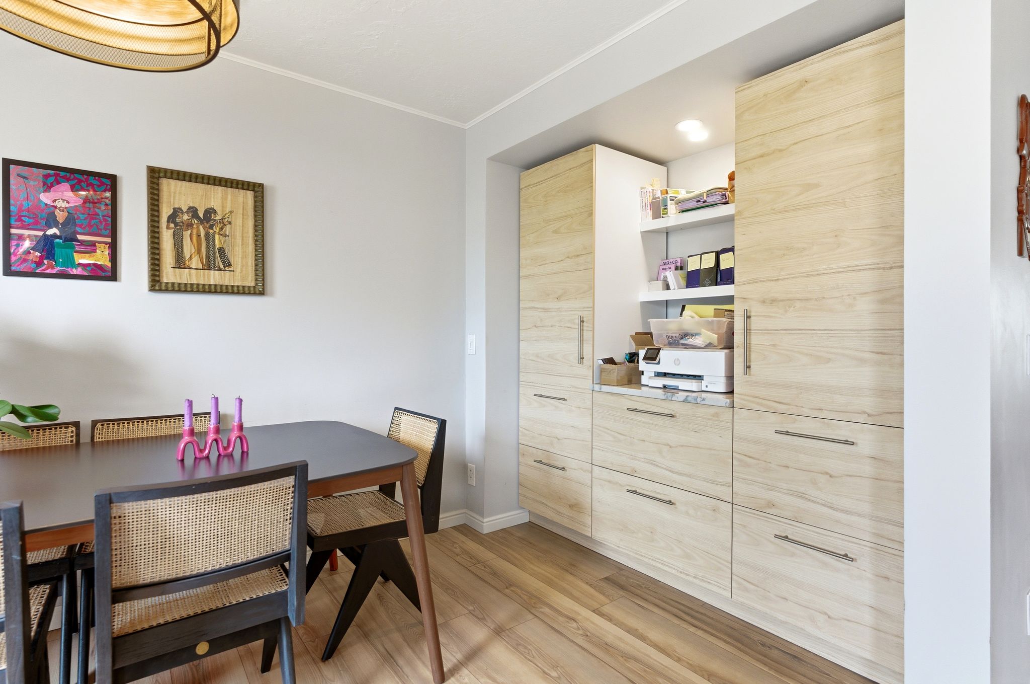 Dining area featuring ornamental molding and light wood-style flooring