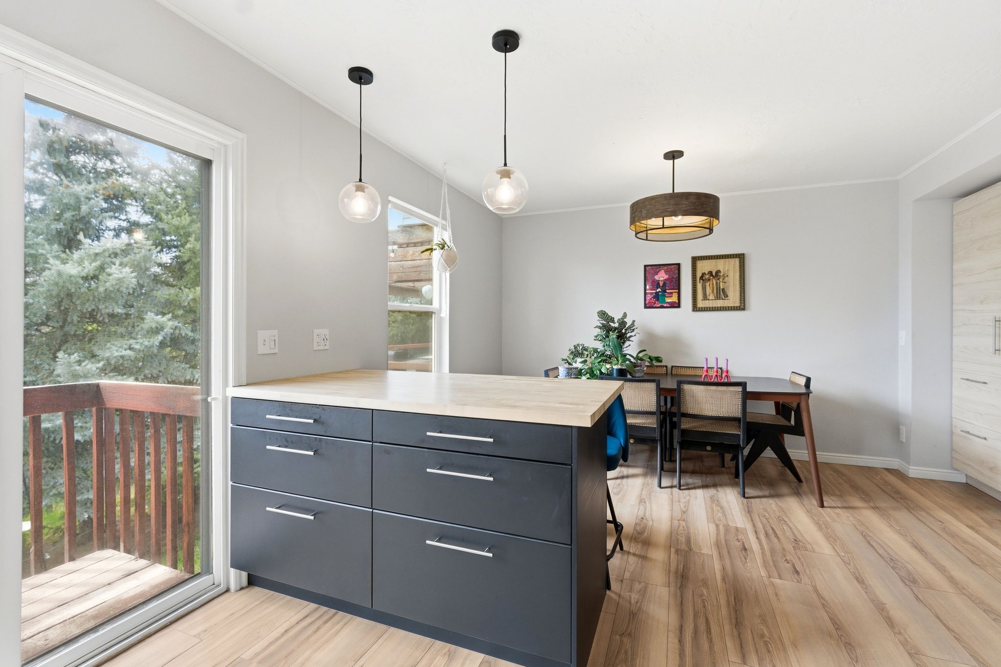 Kitchen featuring a peninsula, light wood-style flooring, and decorative light fixtures