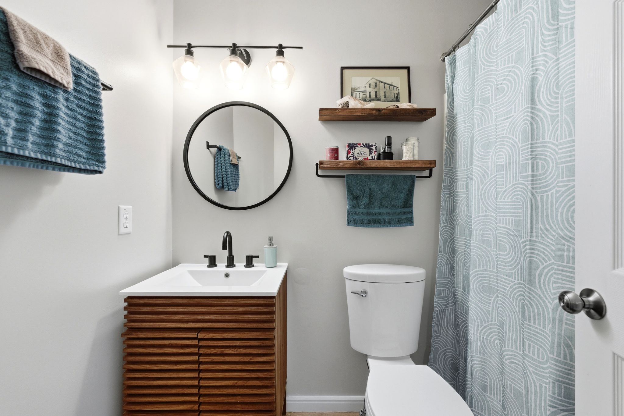 Bathroom featuring vanity and curtained shower