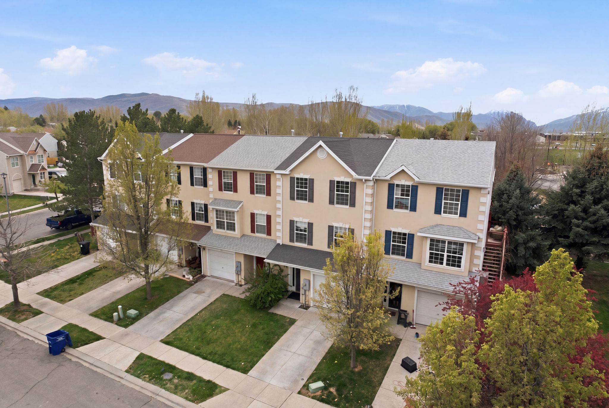View of front of property featuring concrete driveway, a mountain view, an attached garage, and covered porch
