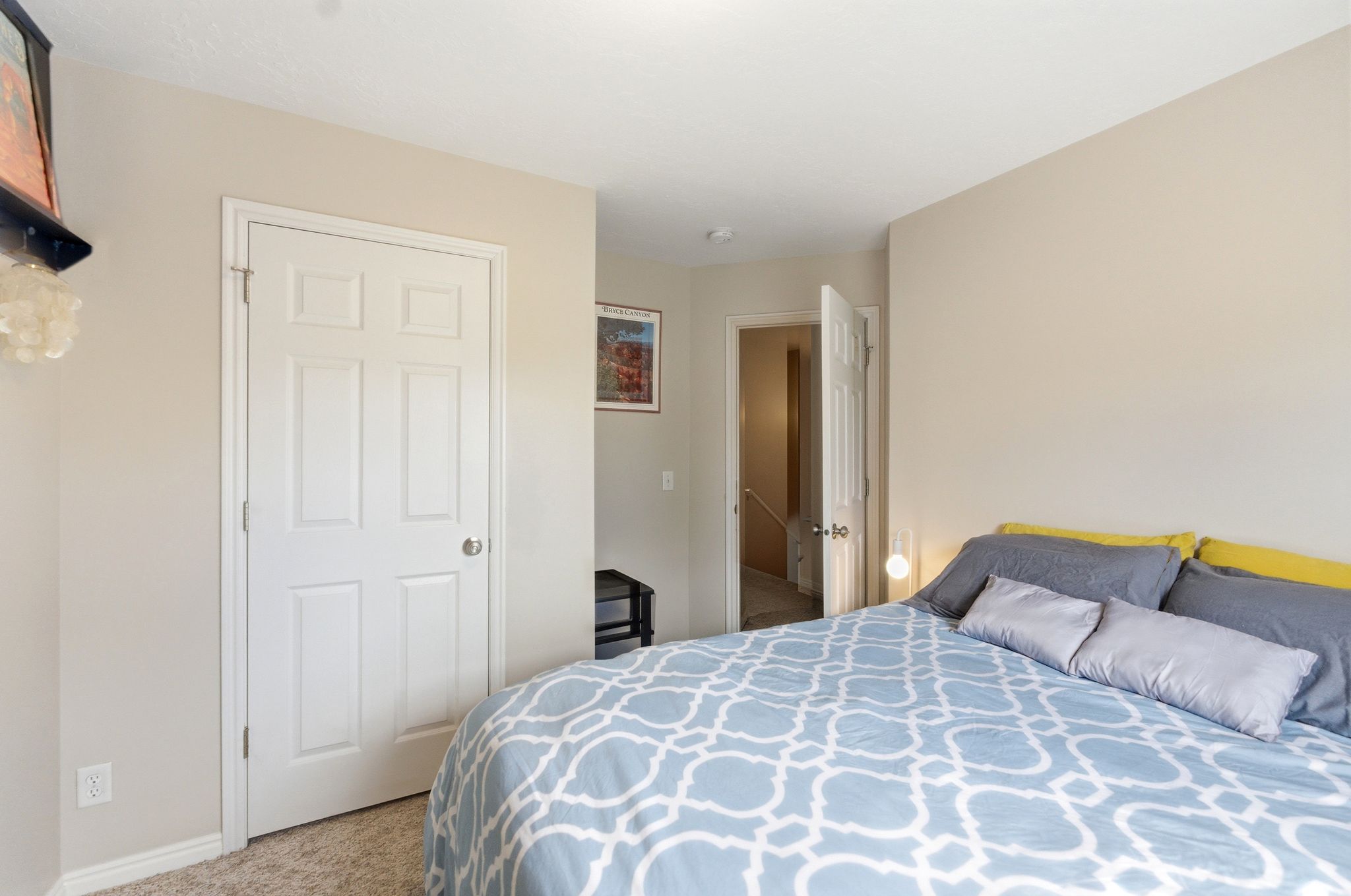 Bedroom featuring light colored carpet and baseboards