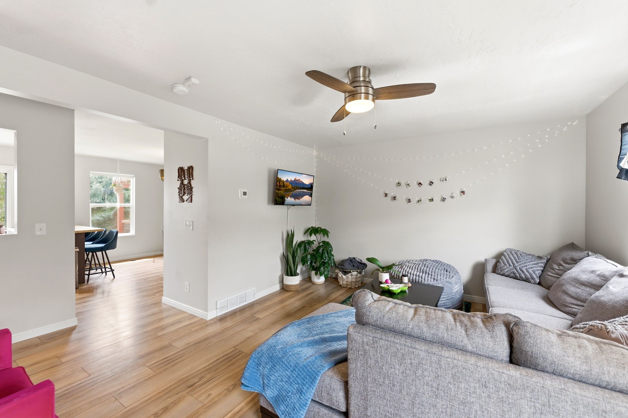 Living room featuring light wood finished floors and a ceiling fan