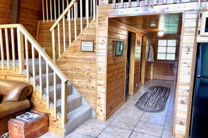 Stairway with wood walls and wood ceiling