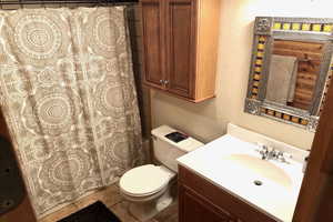 Bathroom with vanity, curtained shower, and a textured wall