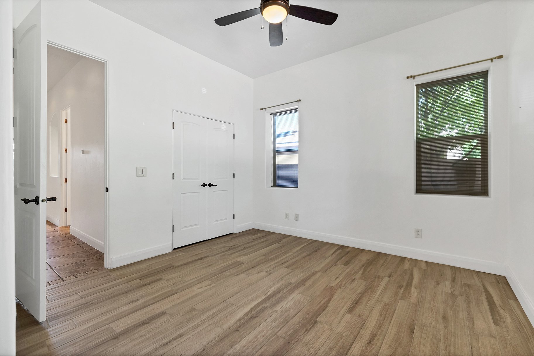 Unfurnished bedroom with light wood-style flooring, a closet, and ceiling fan