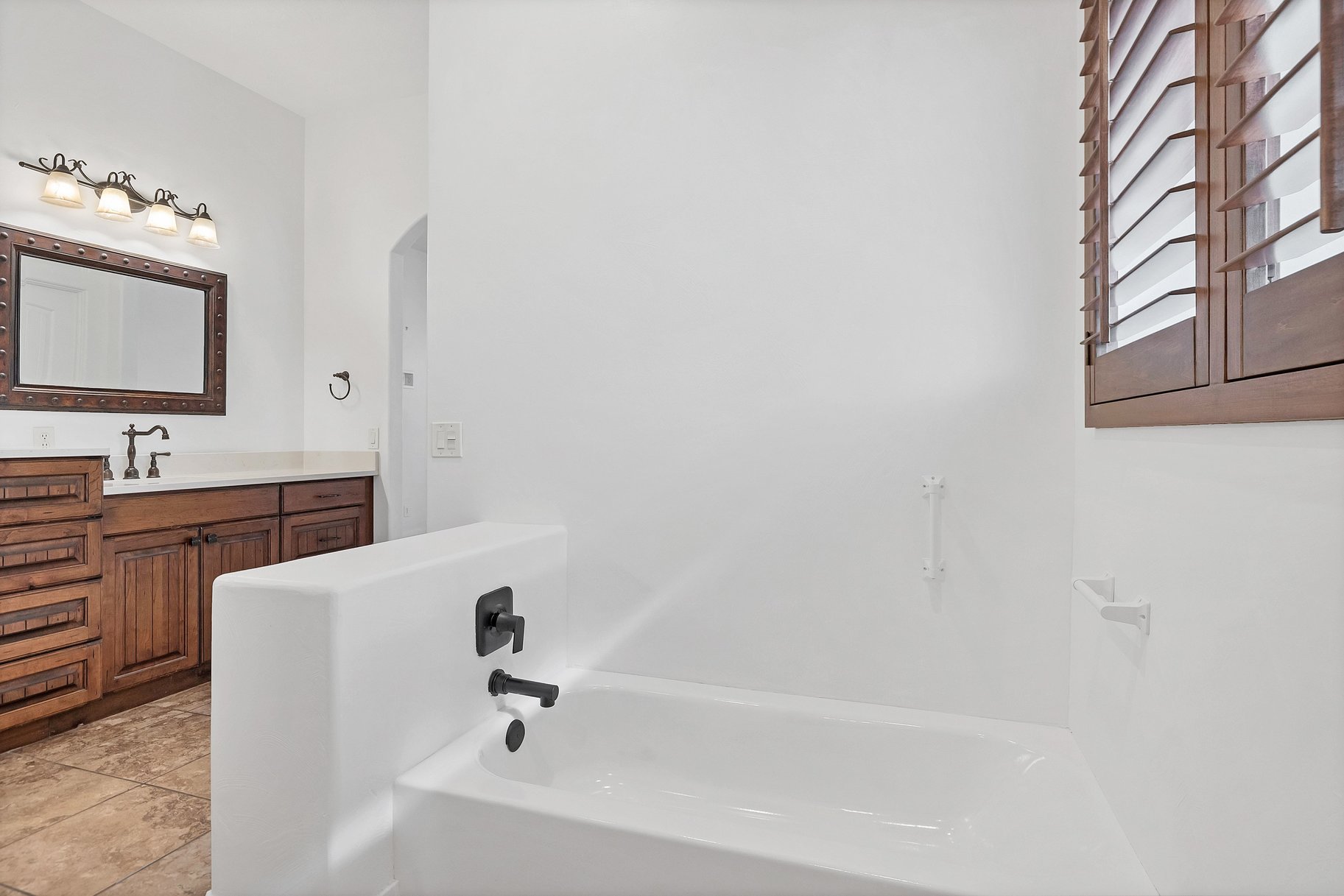 Bathroom featuring vanity and a garden tub
