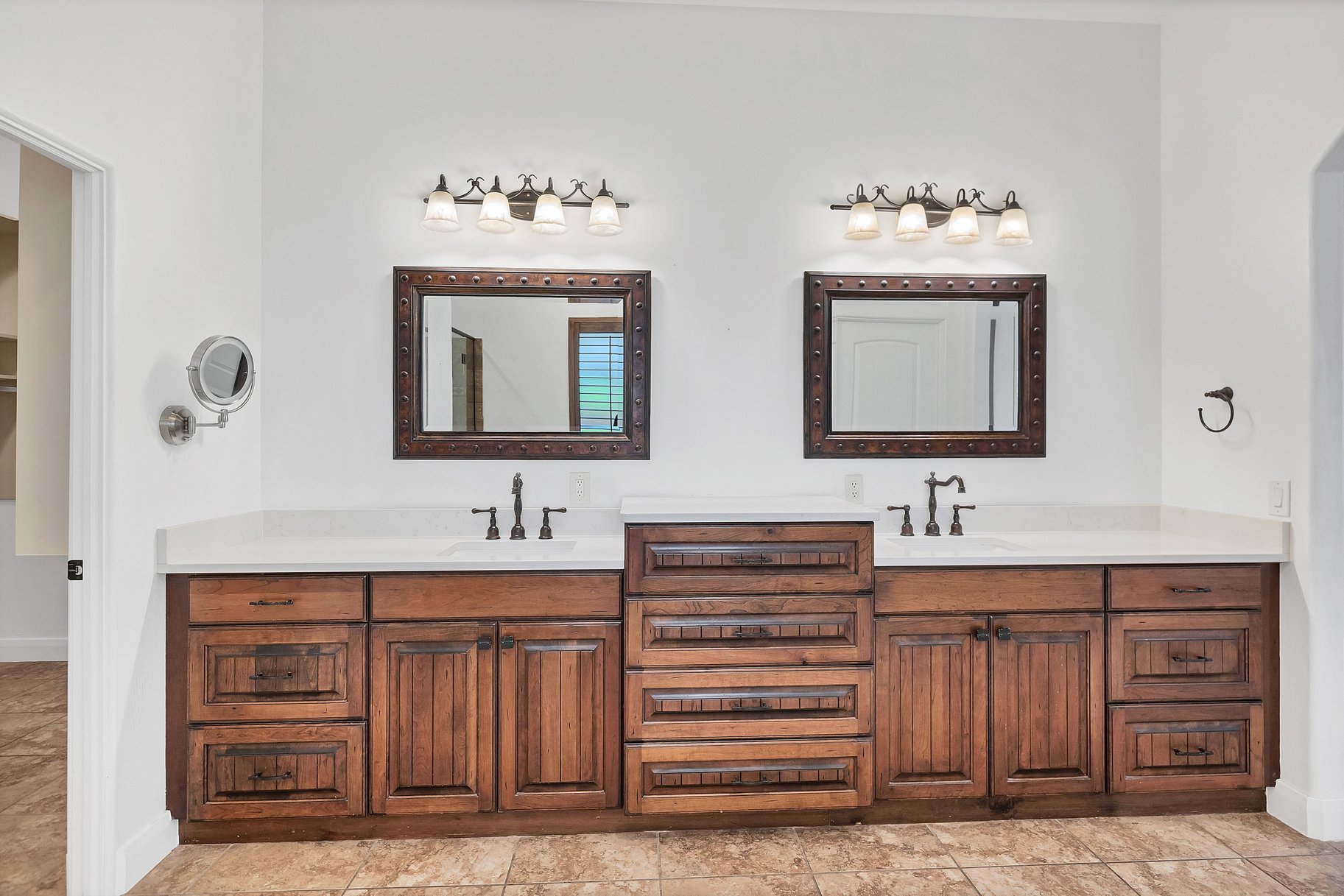 Full bath with double vanity and baseboards