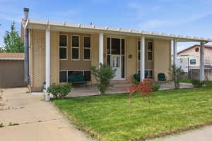 View of front facade featuring covered and brick siding