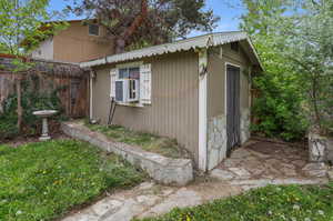 View of home's exterior with an outdoor structure, ADU potential.