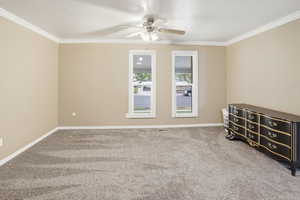 Carpeted bedroom, ornamental molding, and a textured ceiling