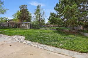 Fenced backyard with a shed