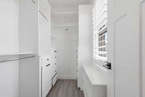 Walk in closet featuring dark carpet
