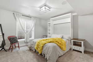 Bedroom with light carpet and baseboards