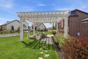 View of yard with a pergola and a patio area