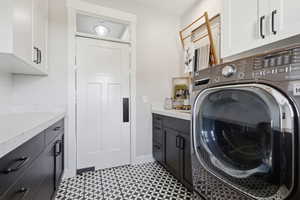 Laundry room with cabinet space and washer / clothes dryer