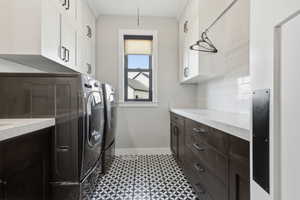 Laundry room with cabinet space and washing machine and clothes dryer