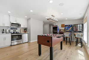 Playroom featuring light wood-style flooring and recessed lighting