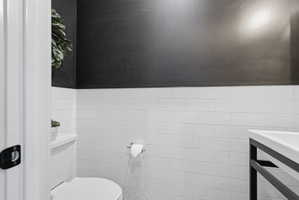 Bathroom with tile walls and wainscoting