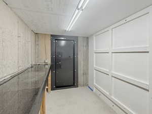 Miscellaneous room with unfinished concrete floors