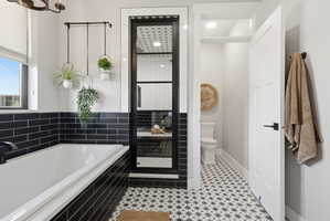 Bathroom with a garden tub and a shower stall