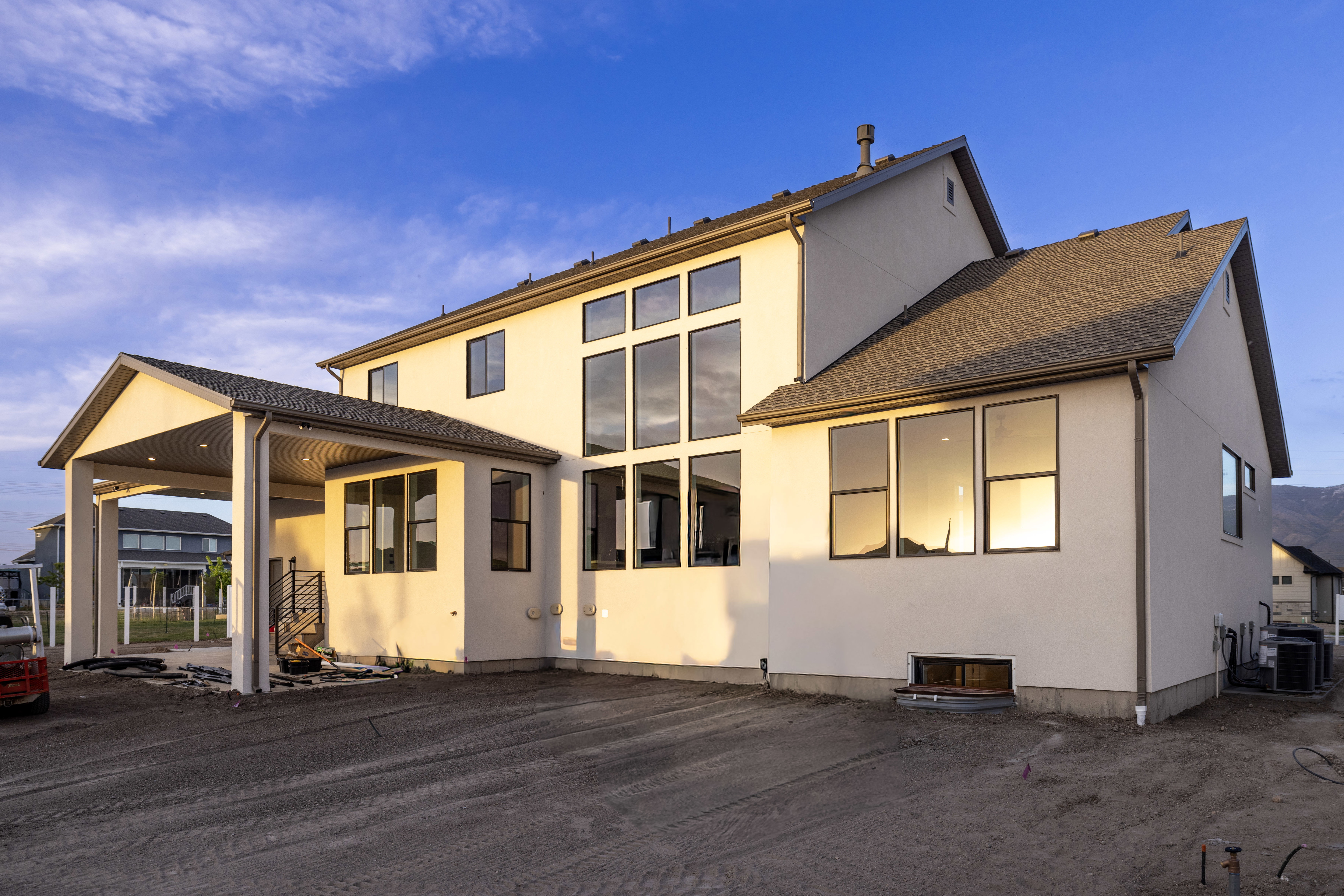 Rear view of house with stucco siding and a patio area