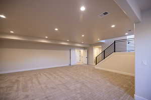 Unfurnished living room featuring light carpet and recessed lighting