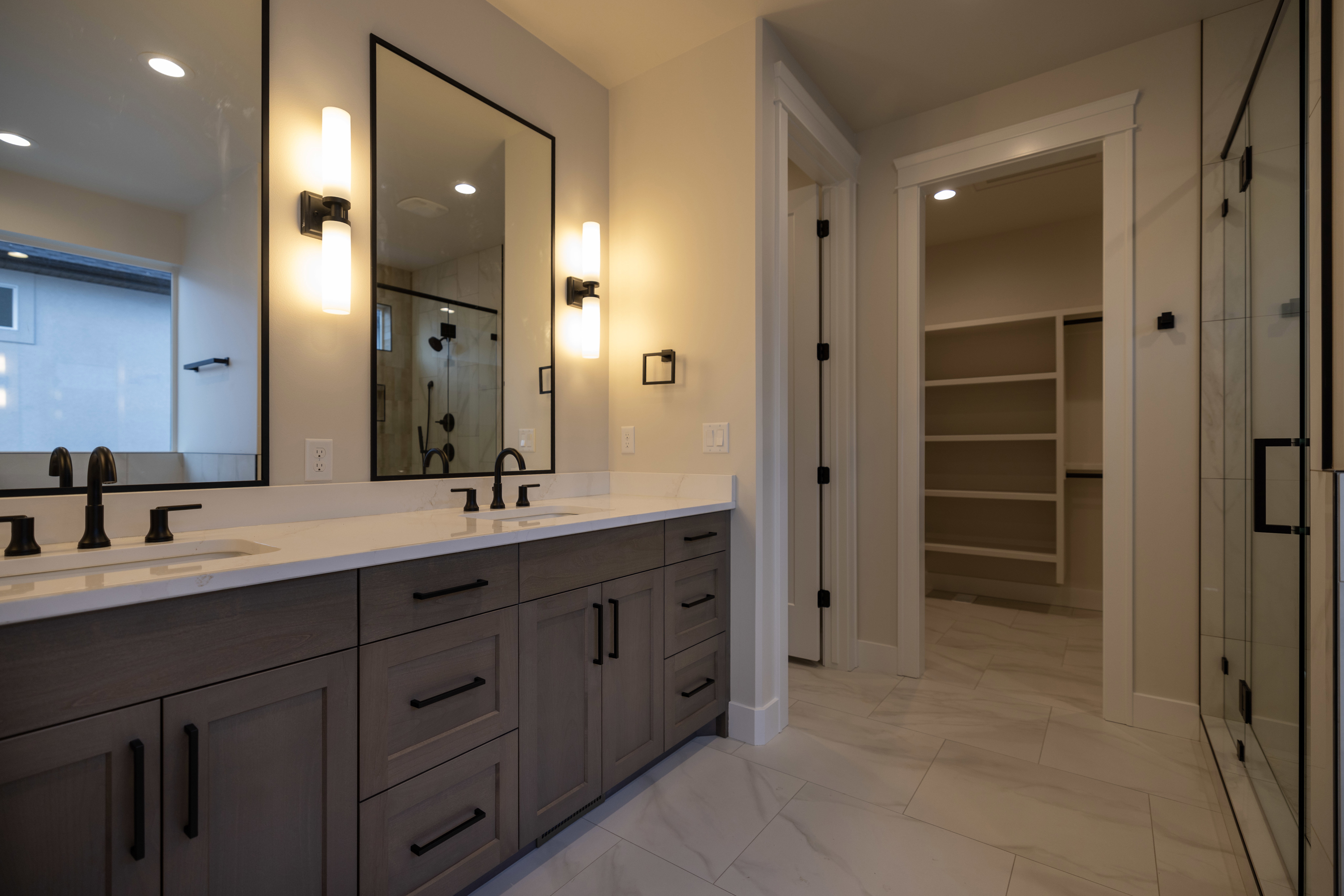 Master Bathroom with double vanity, a walk in closet, and recessed lighting