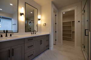Master Bathroom with double vanity, a walk in closet, and recessed lighting