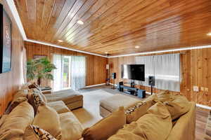 Living area featuring wooden walls, wood finished floors, recessed lighting, and wooden ceiling
