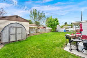 Fenced backyard with a shed