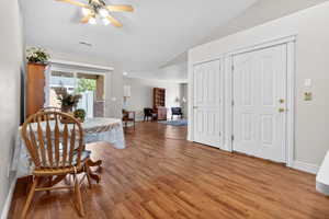 Dining area with ceiling fan, light wood finished floors, and lofted ceiling