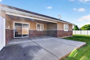 Rear view of house with brick siding