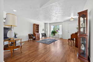 Sitting room featuring a textured ceiling and wood finished floors
