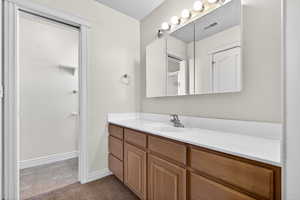 Full bath with vanity and a textured ceiling
