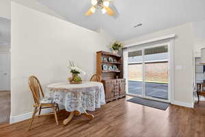 Dining area with lofted ceiling, light wood-style flooring, and ceiling fan